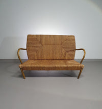 Vintage Franse papercordbank met een metalen frame
