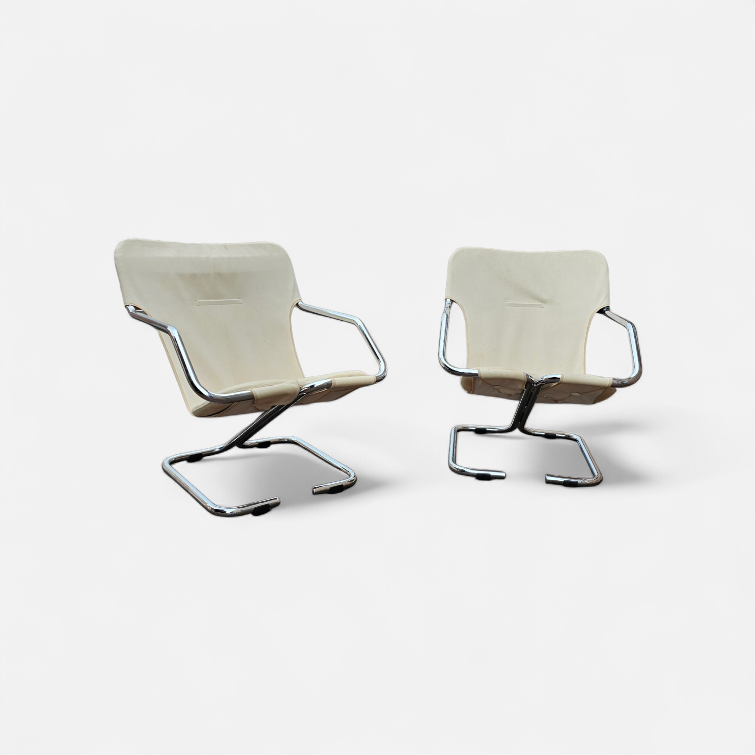 2 x Tubular chrome cantilever chair with a cream canvas sling
