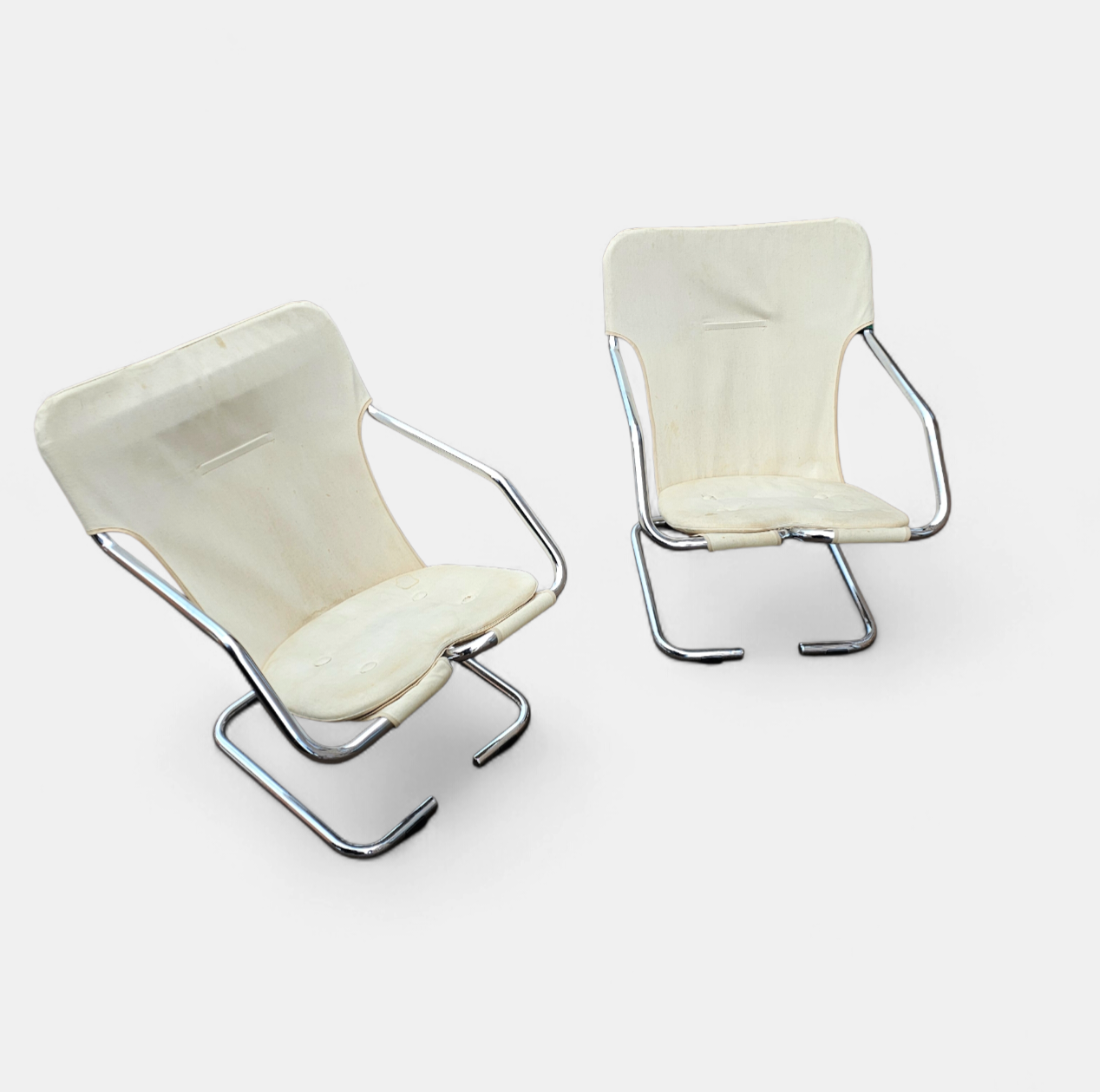 2 x Tubular chrome cantilever chair with a cream canvas sling