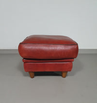 BAXTER hocker/poef in stierenleer.
 Kashmir Rubis kleur 1993