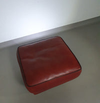 BAXTER hocker/poef in stierenleer.
 Kashmir Rubis kleur 1993