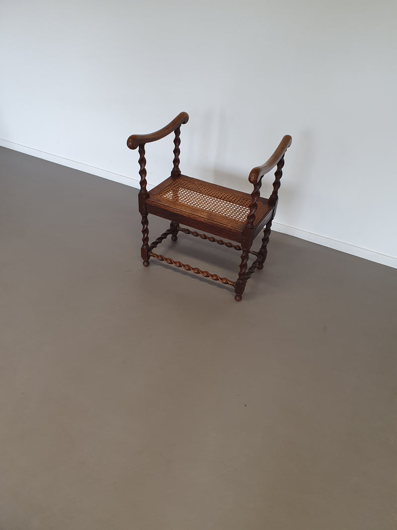 Wokkel stoel met armleuningen en webbing zitting.